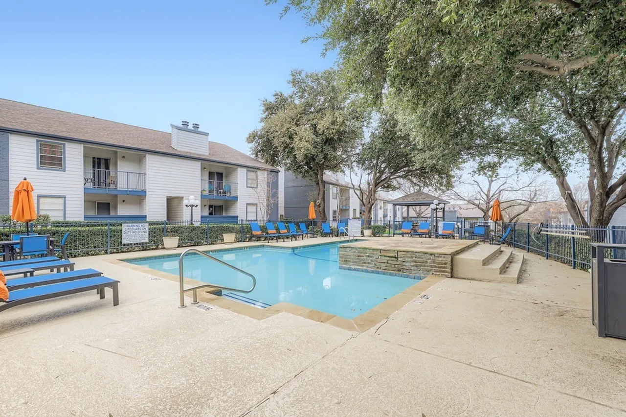 Swimming pool with lounge chairs, trees, residential building, playground equipment, Arlington