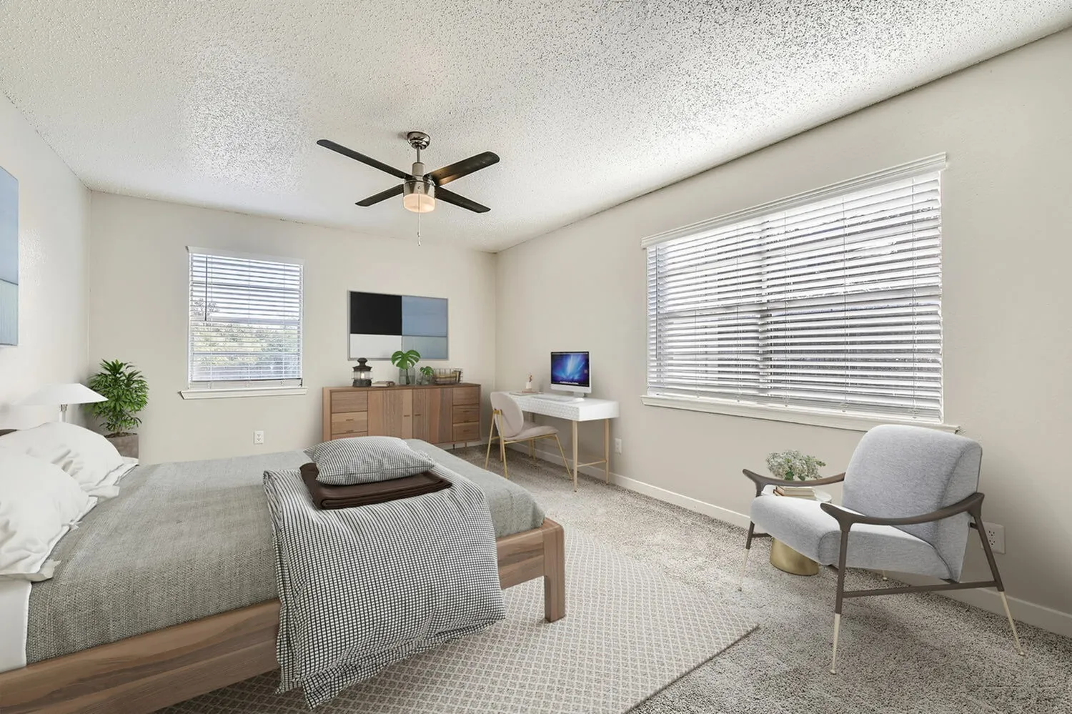 Primary bedroom, wood-style plank flooring, ceiling fan, work desk, natural light