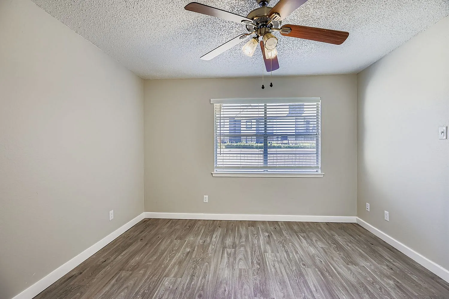 Bedroom, wood-style plank flooring, ceiling fan with light fixture, window with shutters