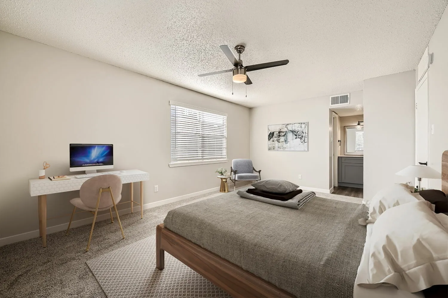Primary bedroom, wood-style plank flooring, ceiling fan, desk with chair, window with blinds