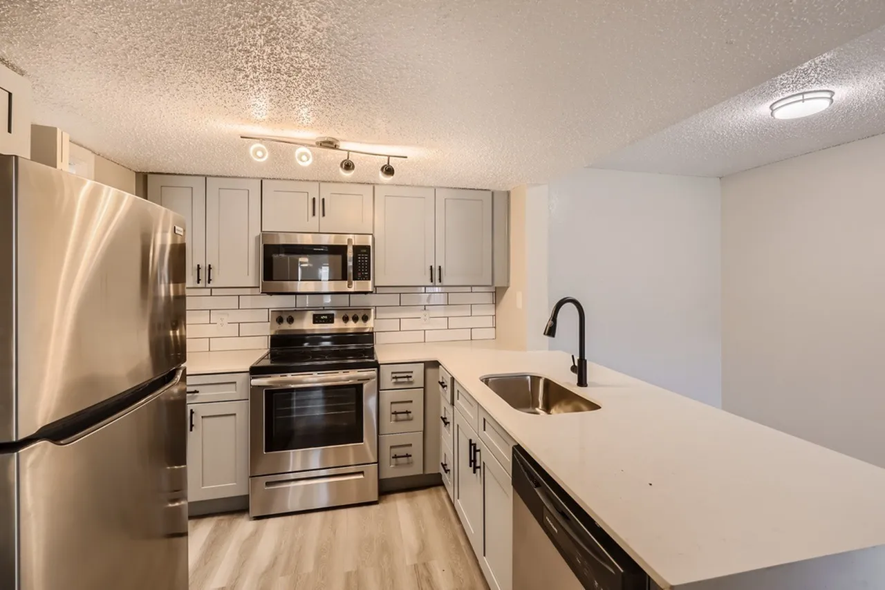 Kitchen, white shaker cabinetry, quartz countertops, stainless appliances, subway tile backsplash