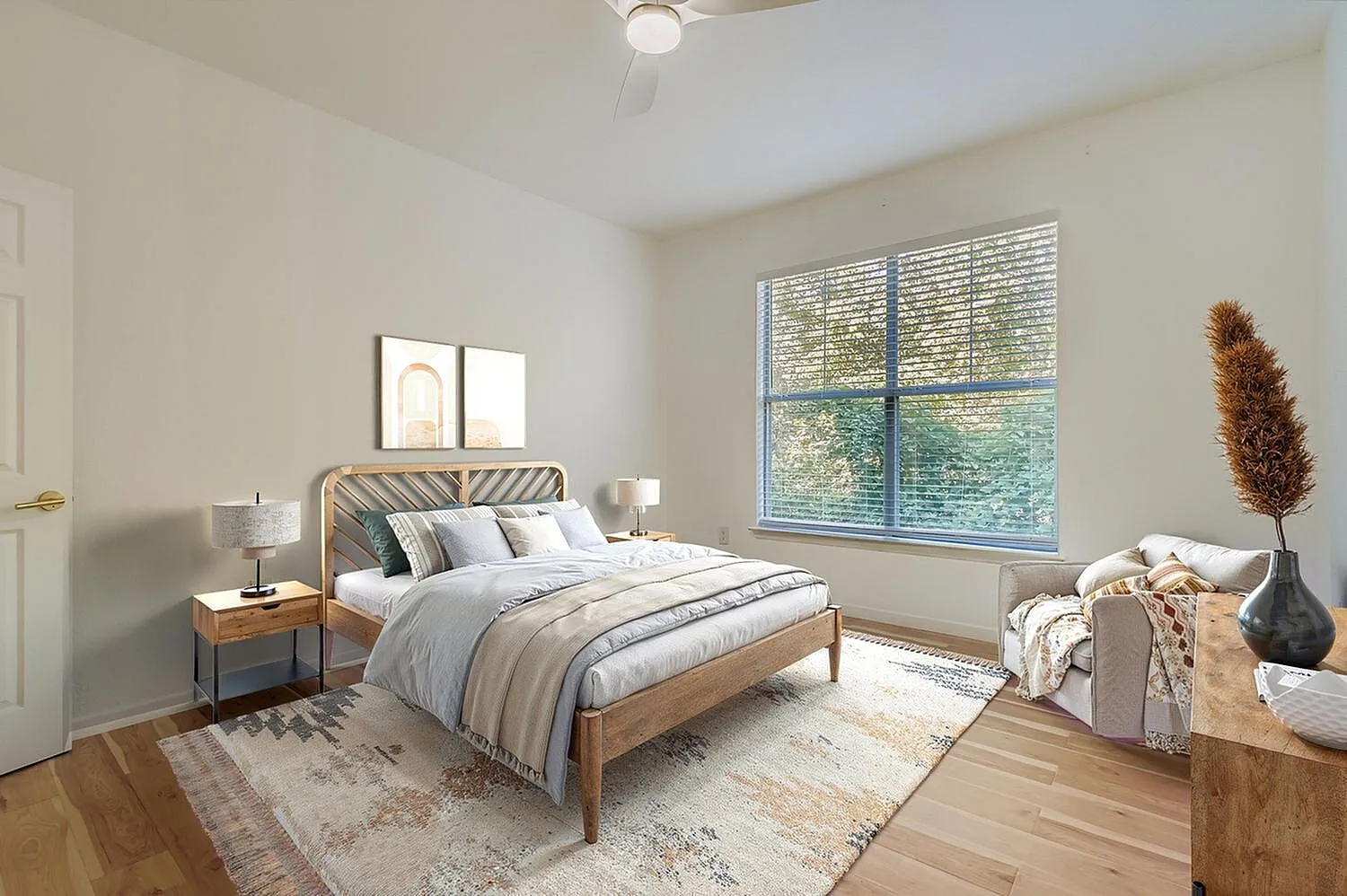Primary bedroom, wood-style plank flooring, large window, wood bed frame, nightstands with lamps