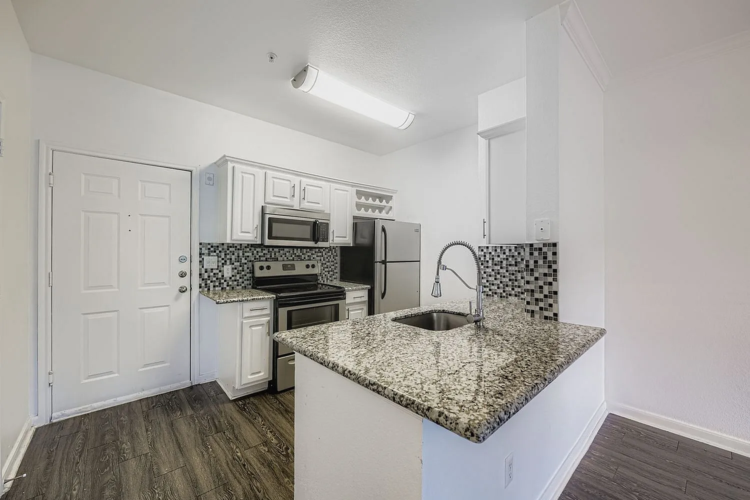 Kitchen, granite countertops, stainless appliances, white shaker cabinetry, mosaic tile backsplash