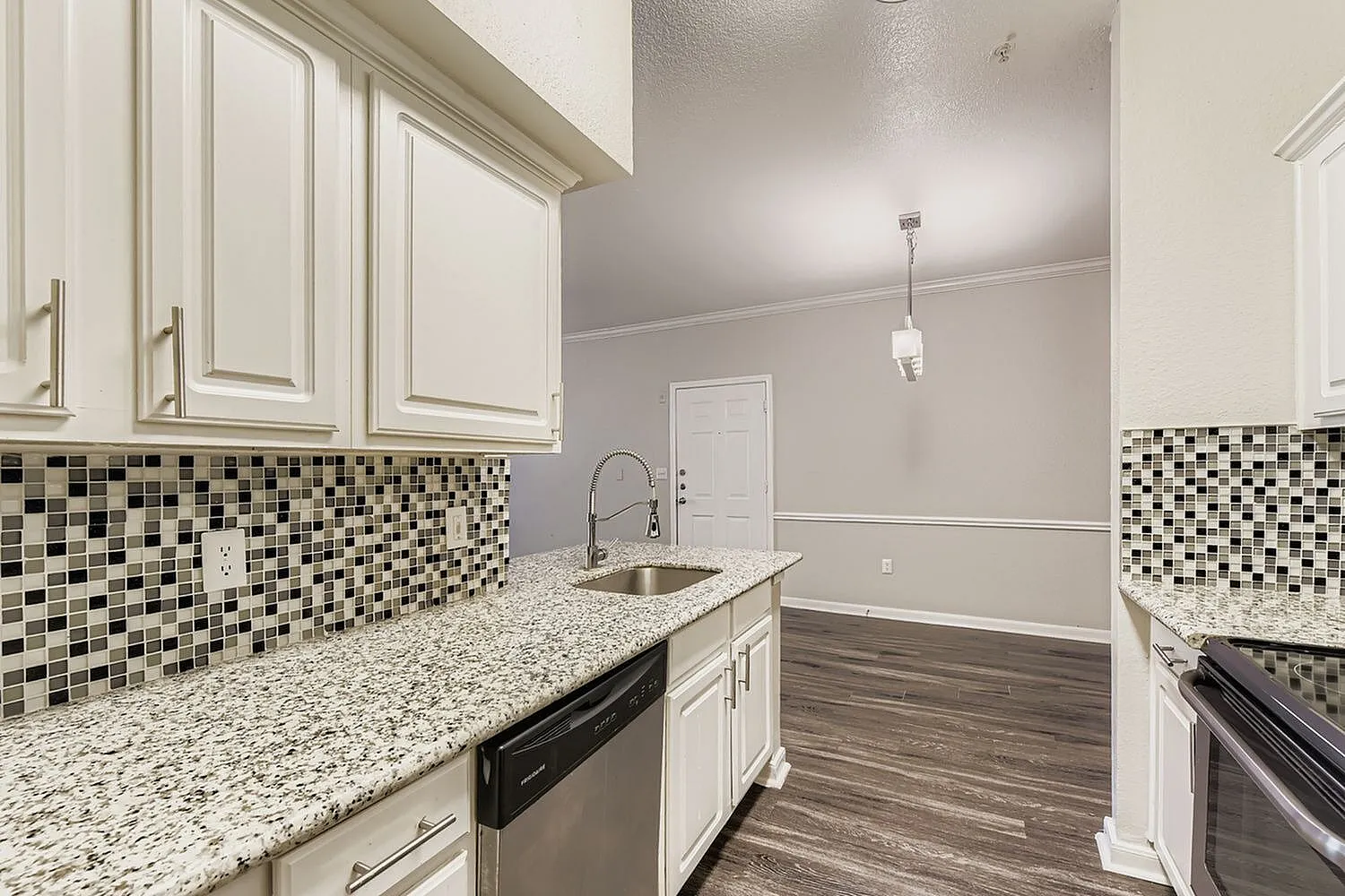 Kitchen, white shaker cabinetry, quartz countertops, mosaic tile backsplash, wood-style plank flooring