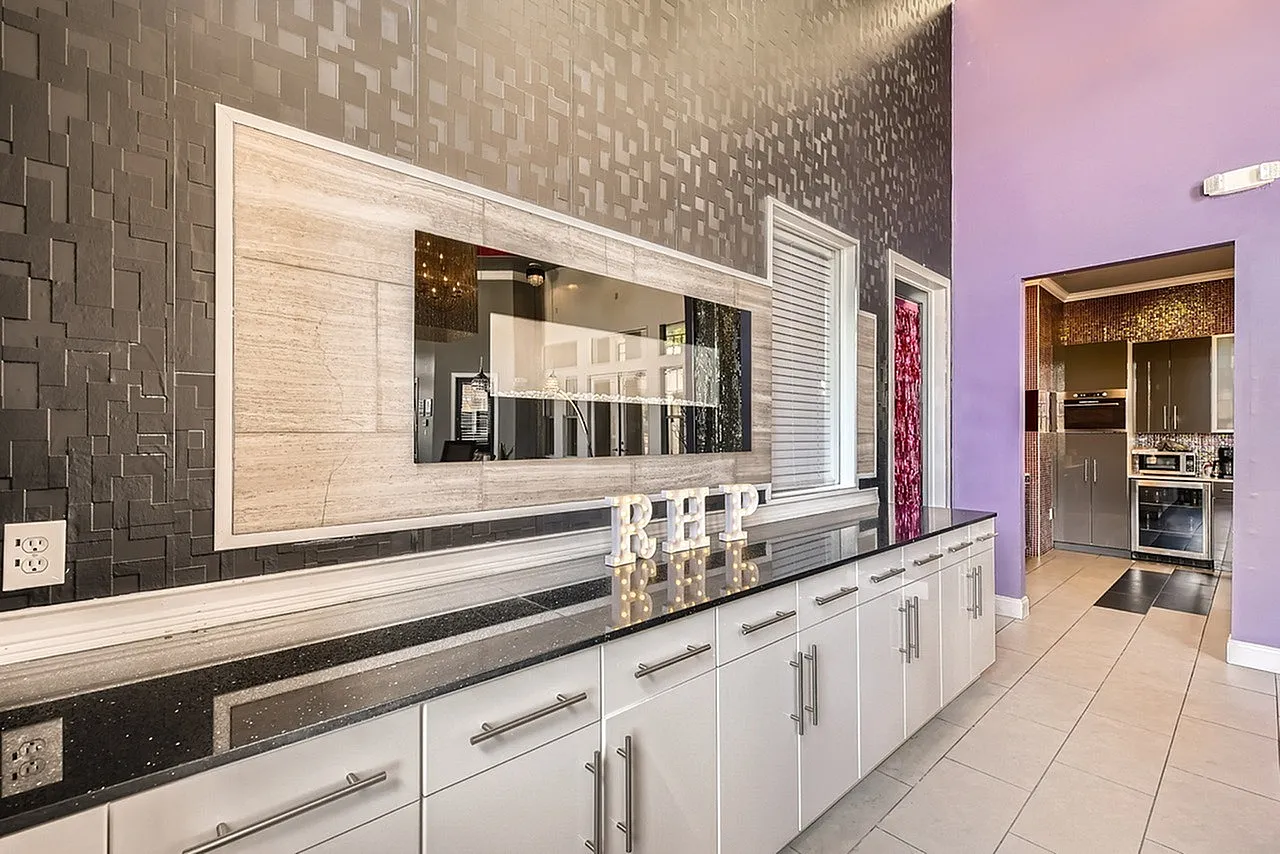 Kitchen, white shaker cabinetry, black quartz countertops, stainless appliances, tile backsplash