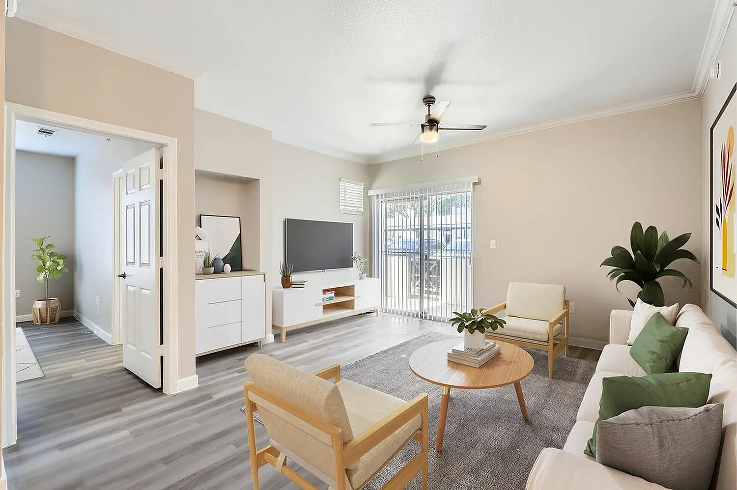 Living room, wood-style plank flooring, ceiling fan, gray area rug, upholstered seating