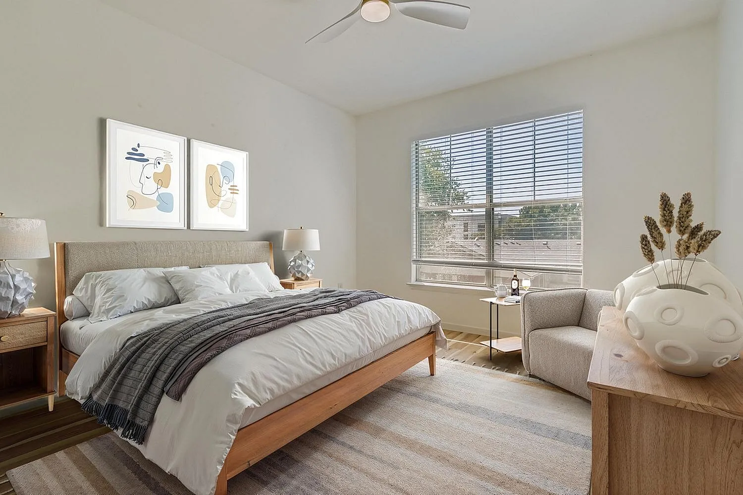 Primary bedroom, wood-style plank flooring, upholstered headboard, ceiling fan, large windows