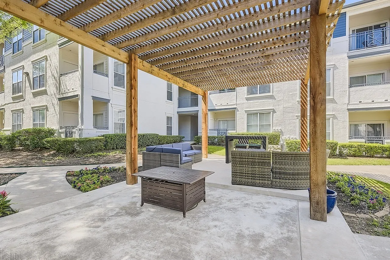 Courtyard, wooden pergola, concrete patio, modern seating, landscaping