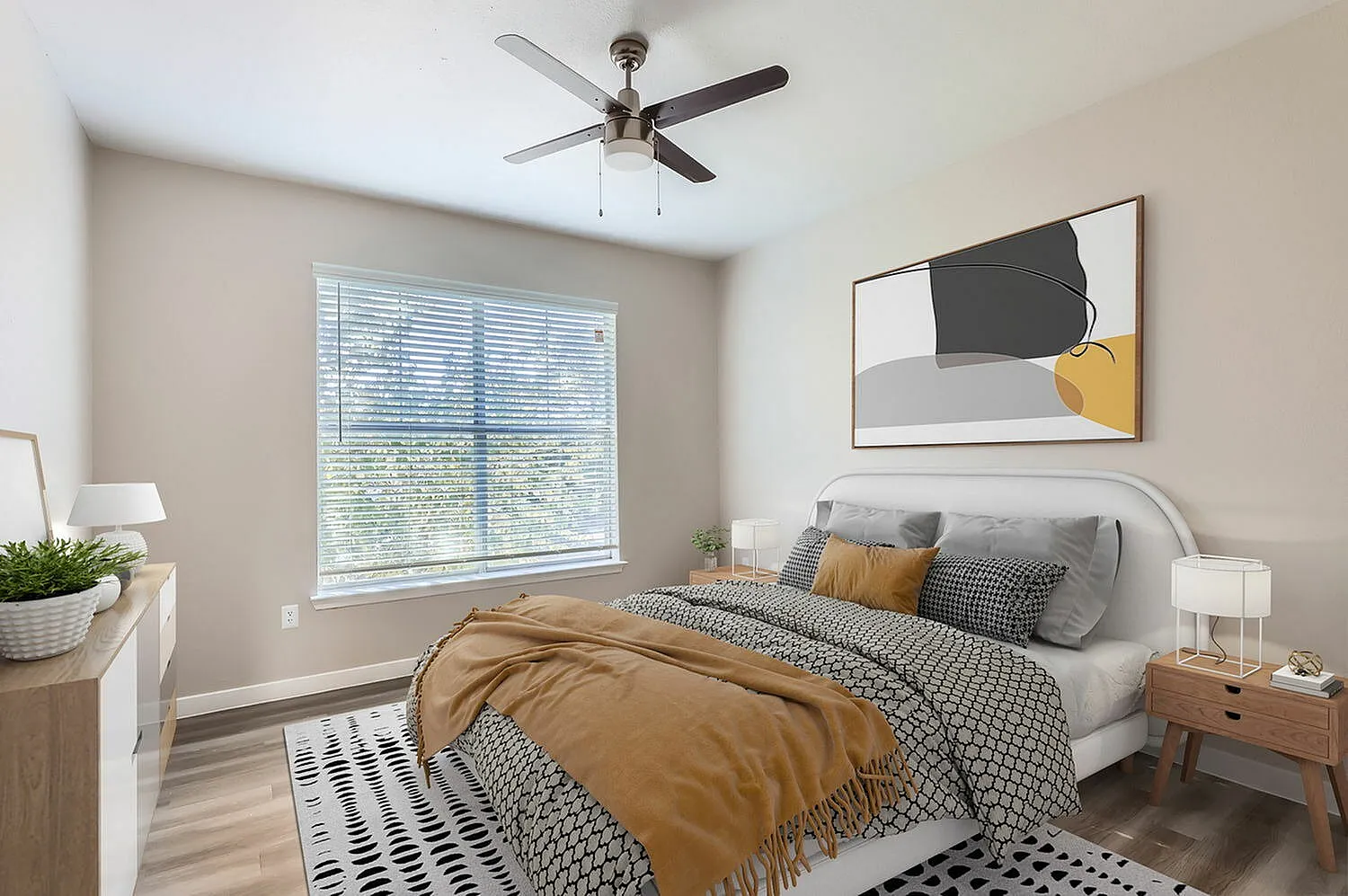 Bedroom, wood-style plank flooring, ceiling fan, upholstered bed frame, abstract wall art