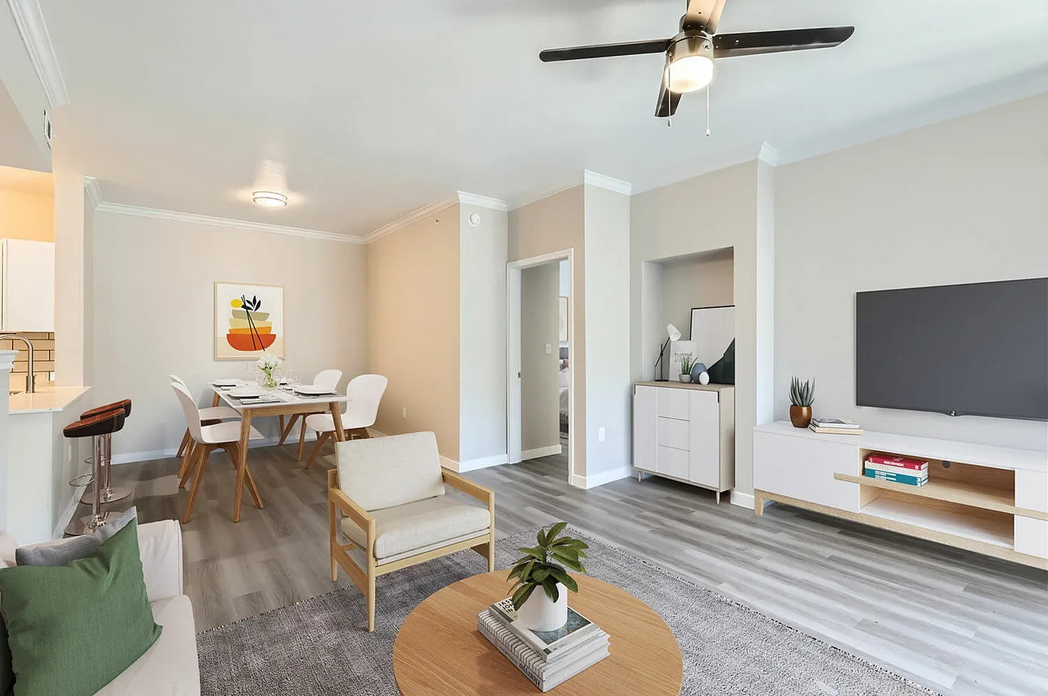 Open concept living space, wood-style plank flooring, ceiling fan, dining table with chairs