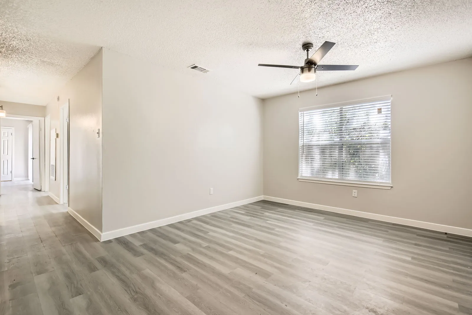 C1 Renovated floor plan, wood-style plank flooring, ceiling fan, large window