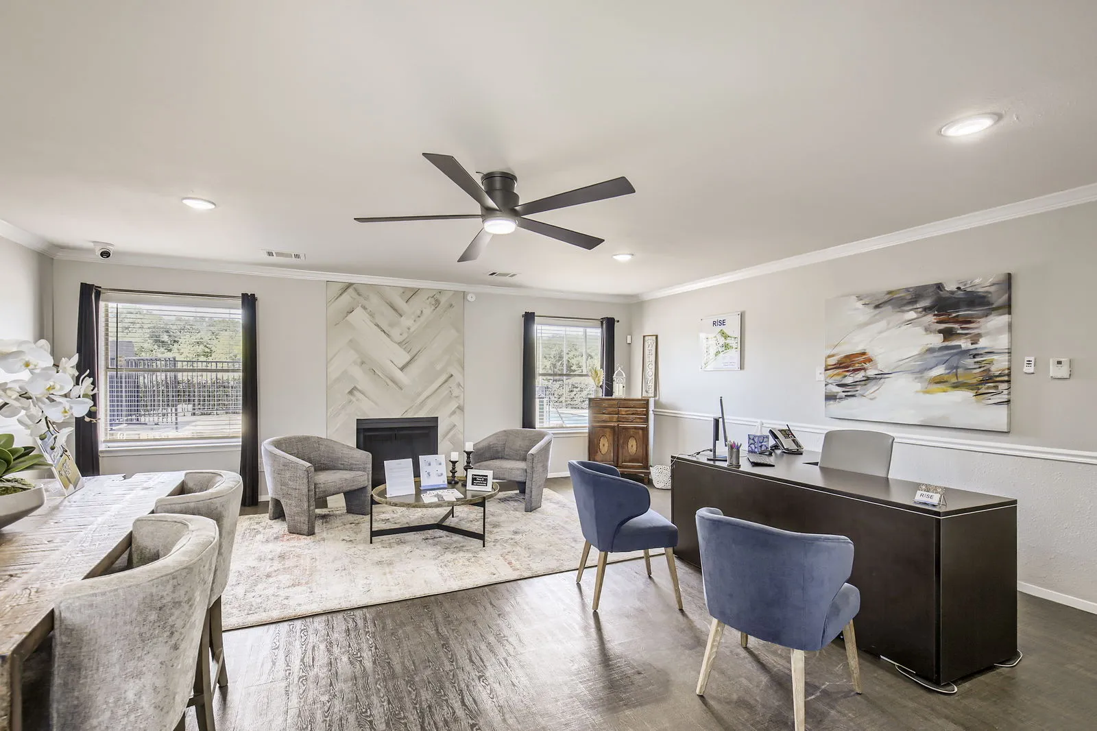 Leasing office, decorative fireplace, wood-style plank flooring, seating area