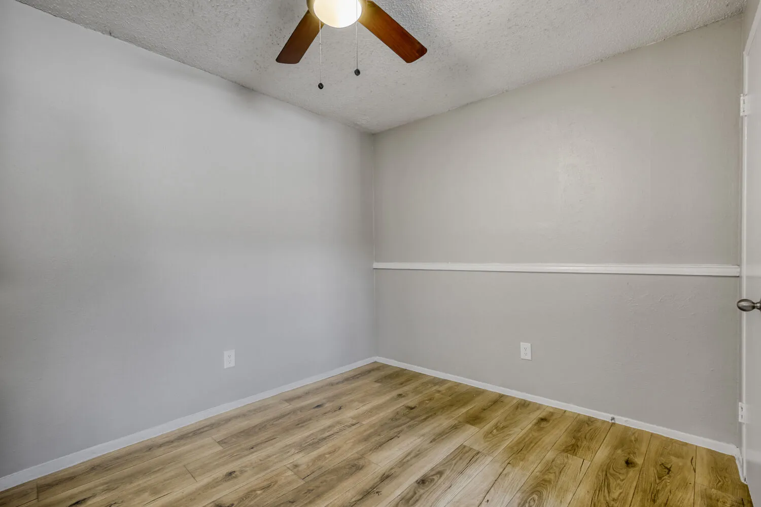 Dining area, wood-style plank flooring, ceiling fan, neutral walls