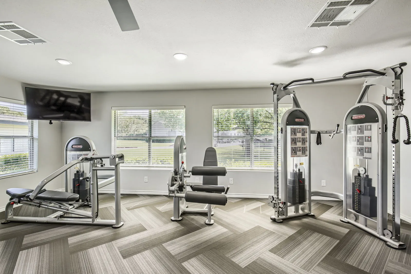 Fitness center, strength training equipment, cable machine, wall-mounted TV