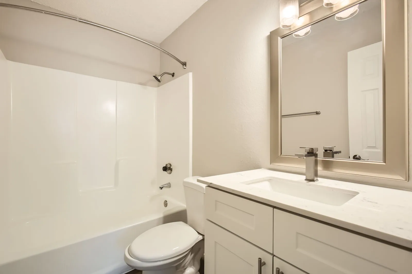 Hallway bathroom, white vanity, quartz countertop, tub-shower combo