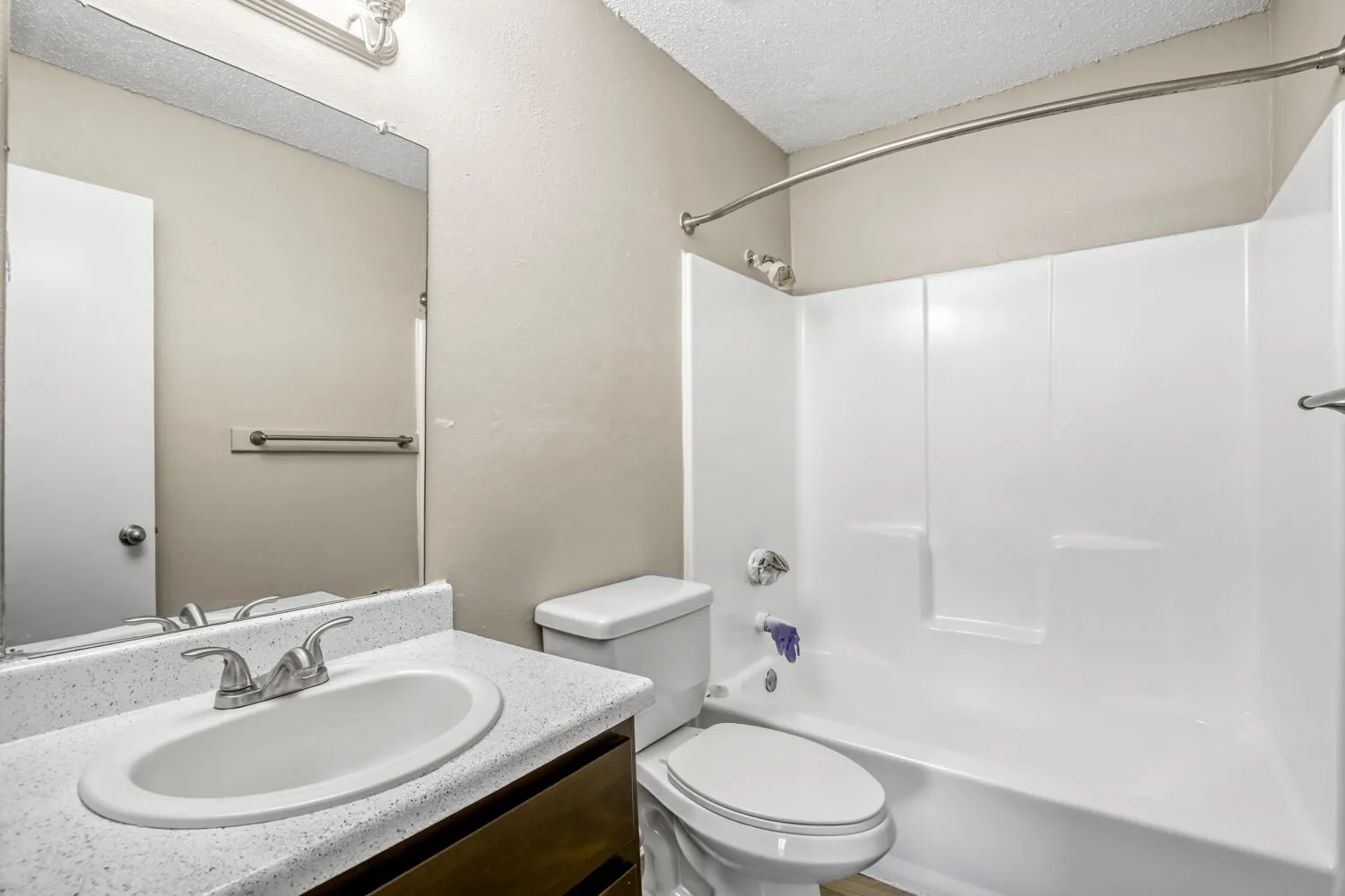 Hallway bathroom, tub-shower combo, vanity, wall-mounted mirror