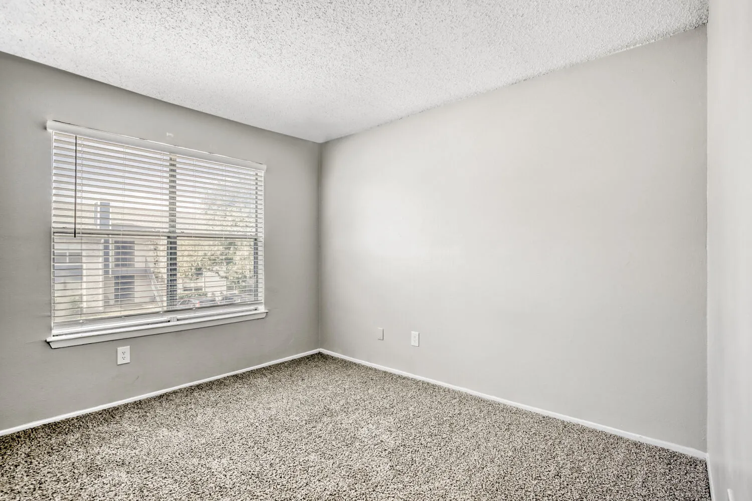 Third bedroom, carpeted flooring, large window, corner view