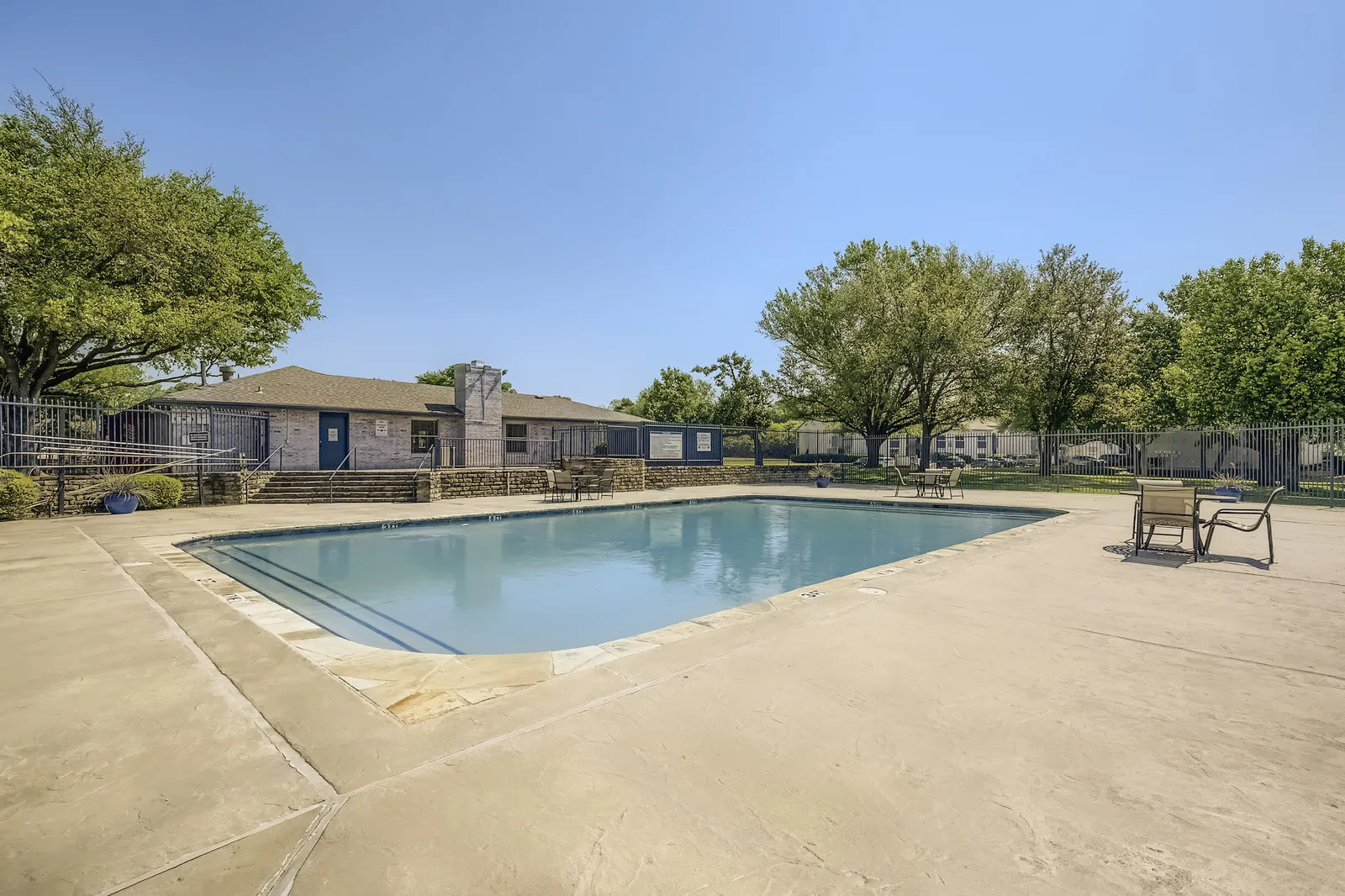 Community pool, patio seating, clubhouse exterior, shaded lawn