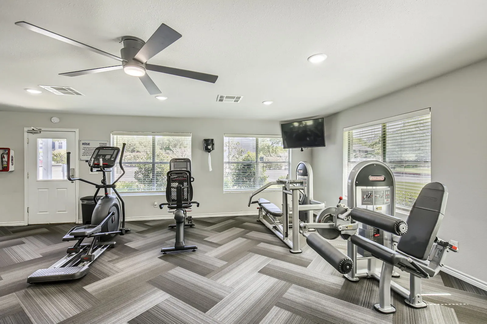 Fitness center, elliptical and cycle equipment, strength machines, wall-mounted TV
