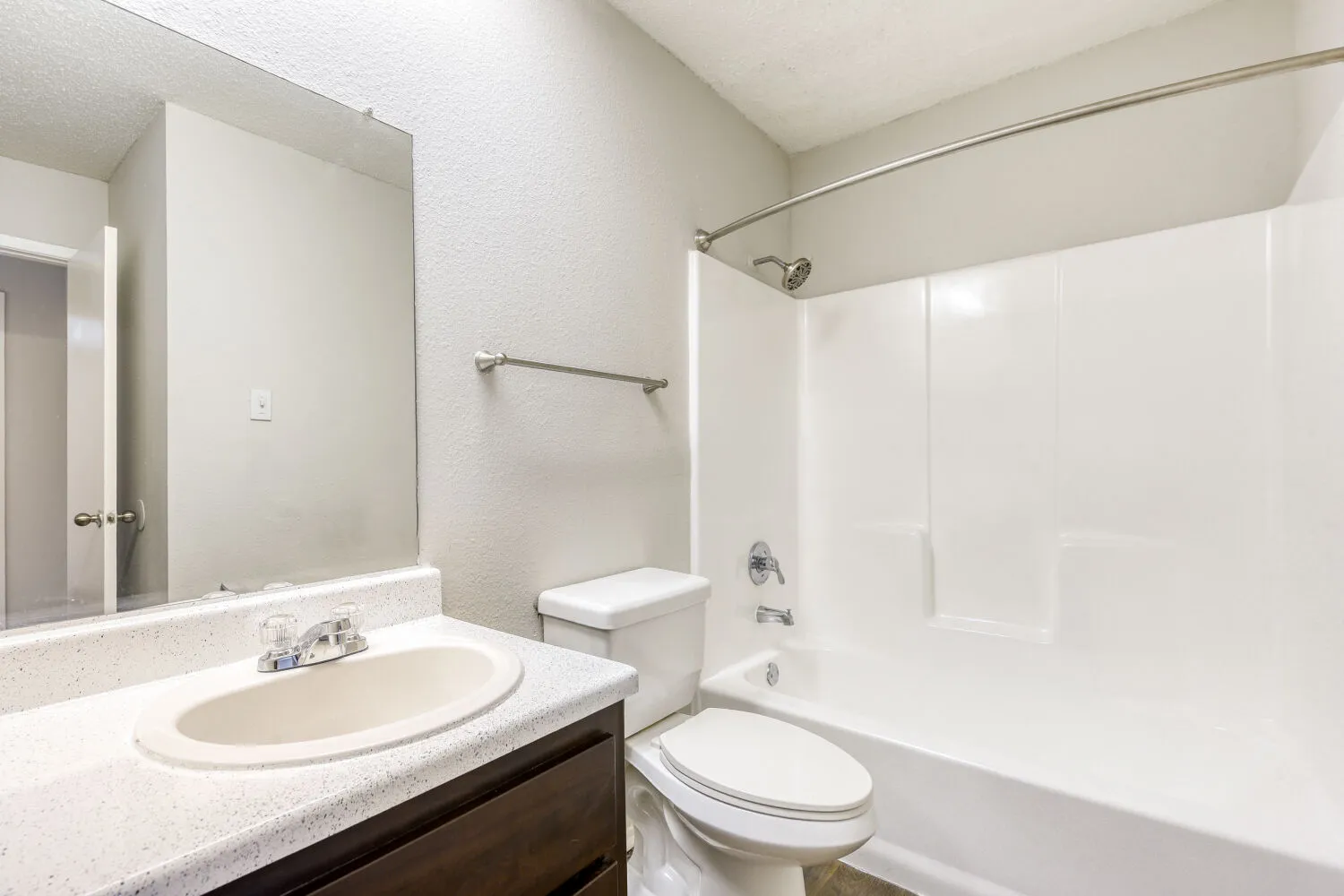 Bathroom with laminate vanity countertop, tub-shower combo