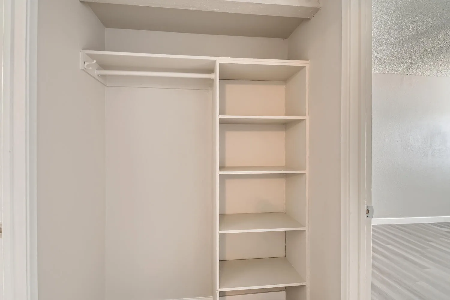 Reach-in hallway closet, built-in shelving, hanging rod