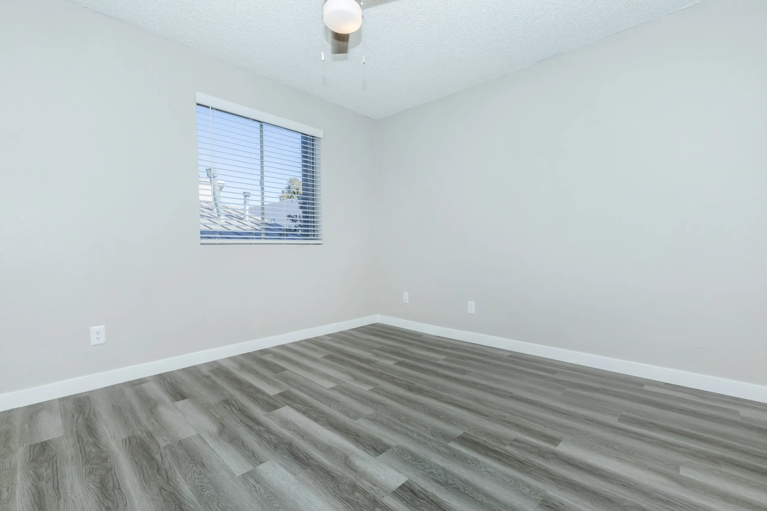 Bedroom, window, ceiling fan, wood-style plank flooring