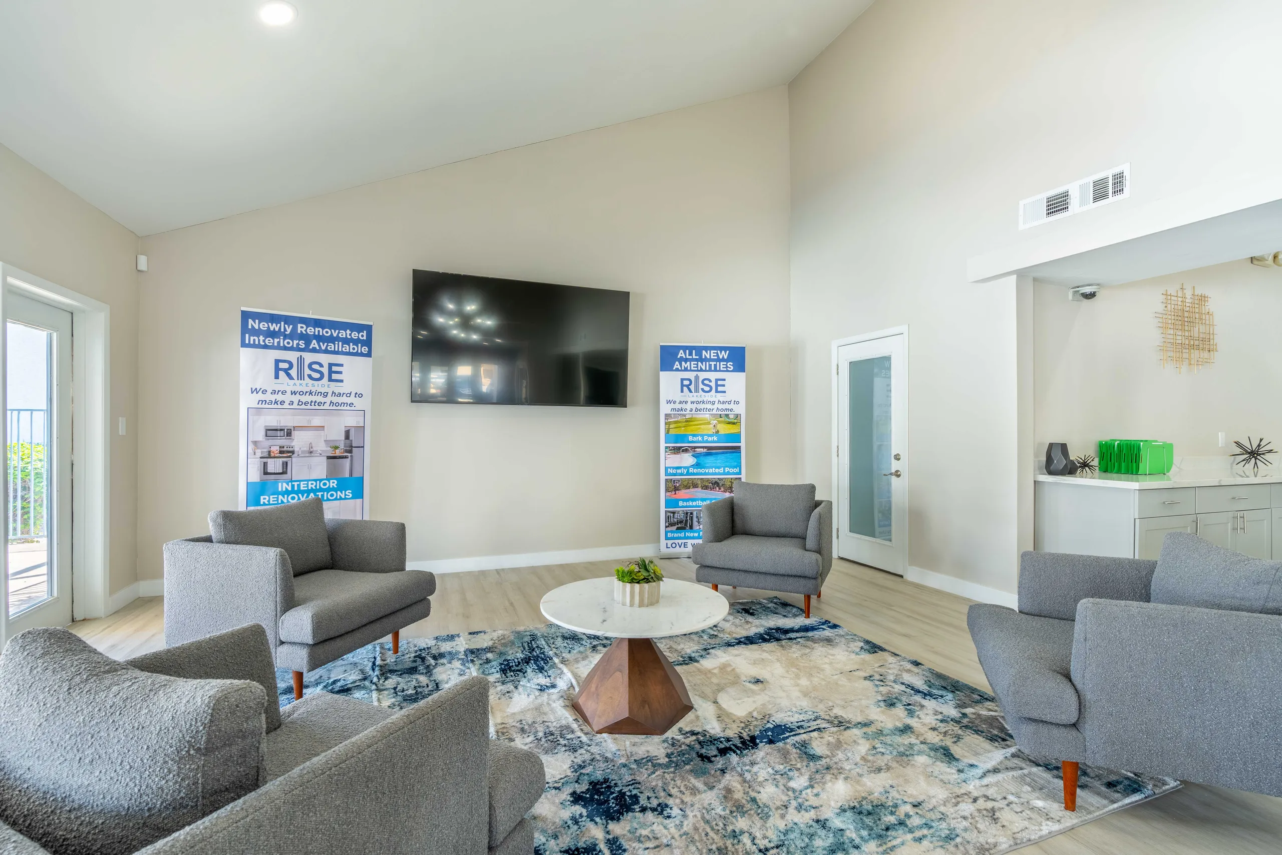 Leasing office lounge, seating area, wall-mounted TV, wet bar