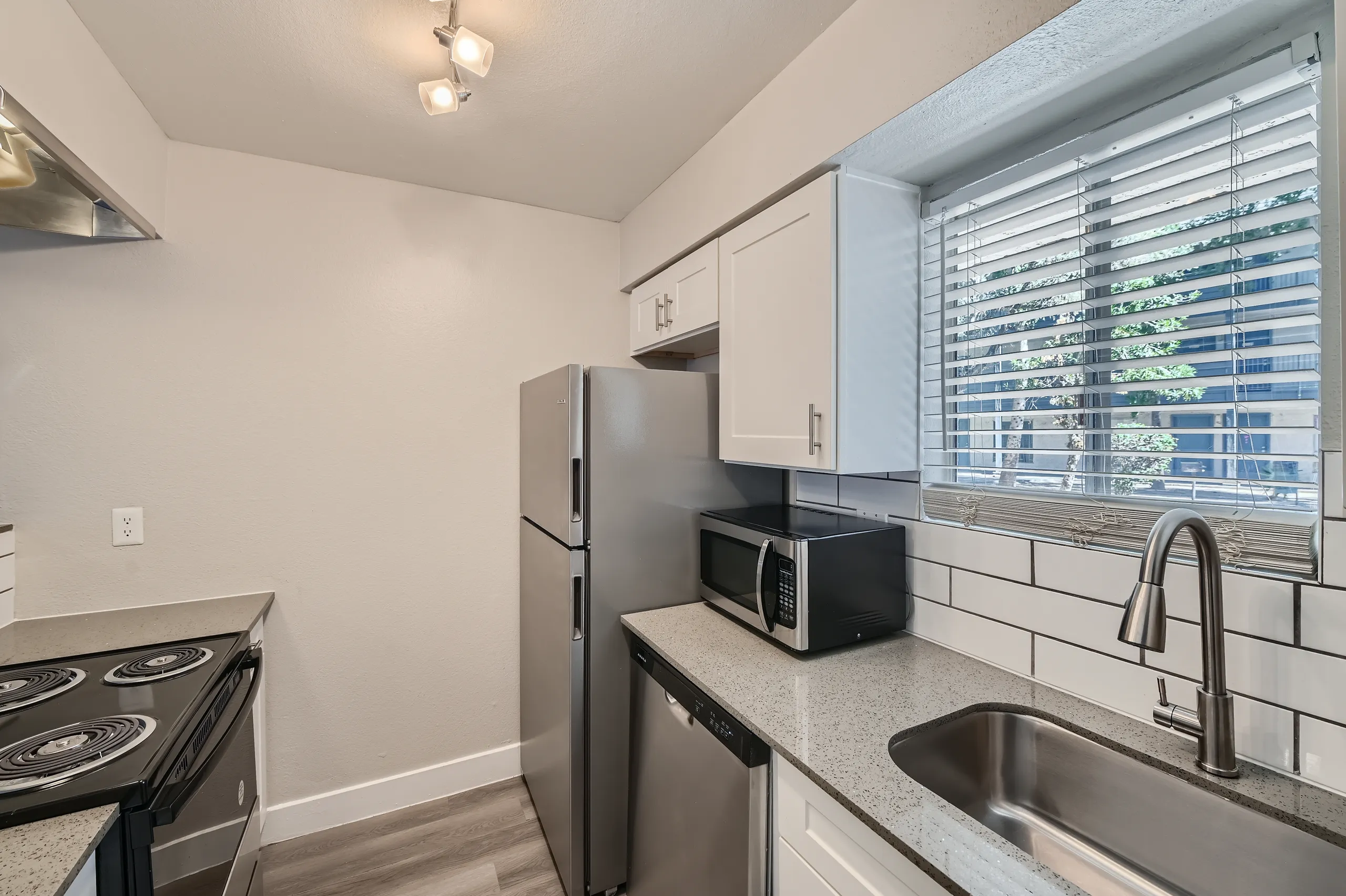 Kitchen, white shaker cabinets, stainless steel appliances, subway tile backsplash