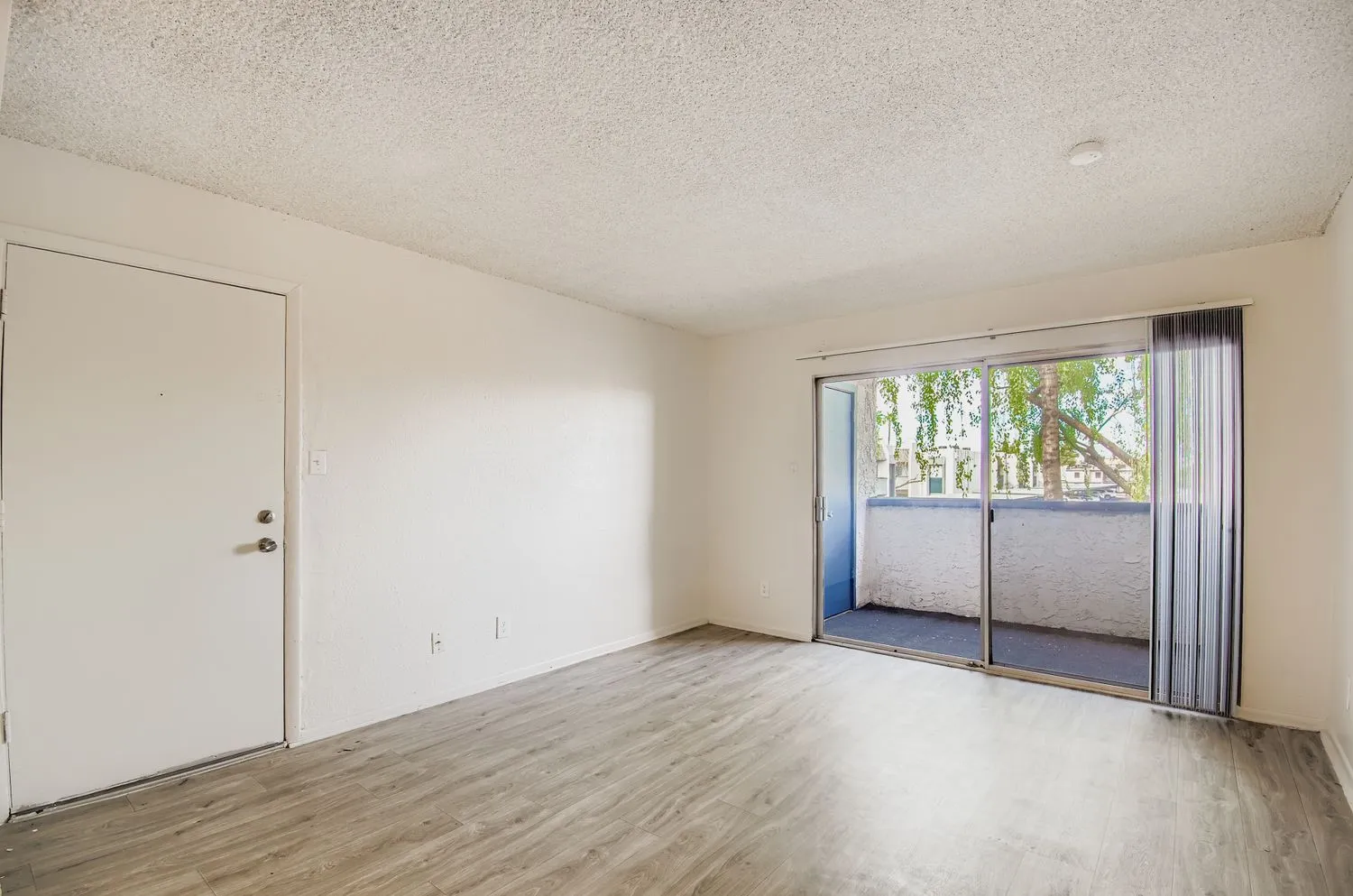 A3 Classic living room, sliding glass door, private patio, wood-style plank flooring