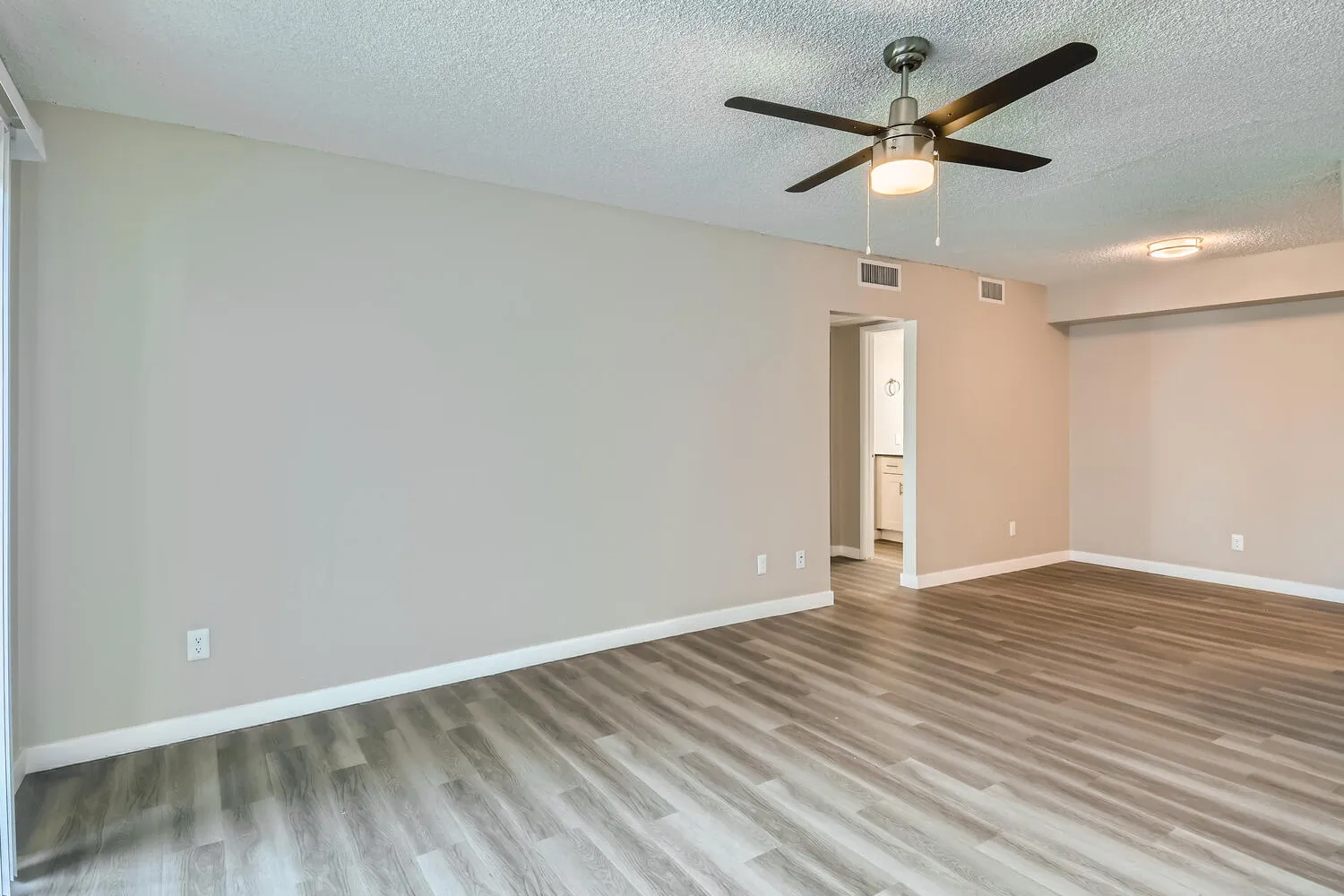 B2 Platinum living room, ceiling fan, wood-style plank flooring, open floor plan