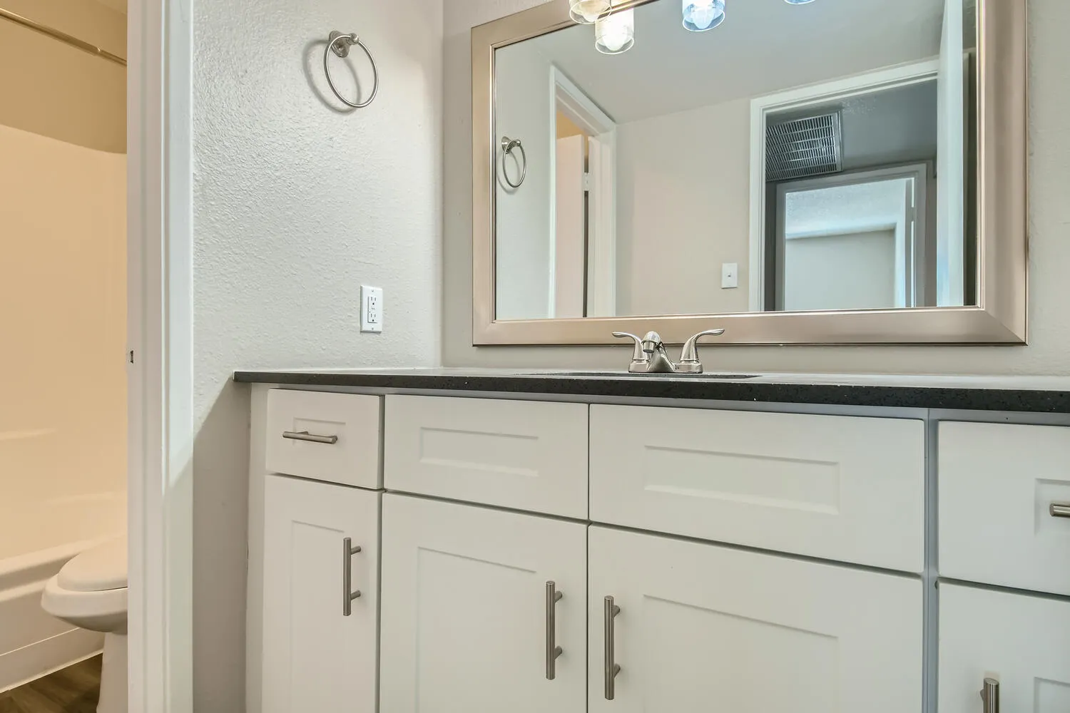 Bathroom, quartz vanity countertop, framed mirror