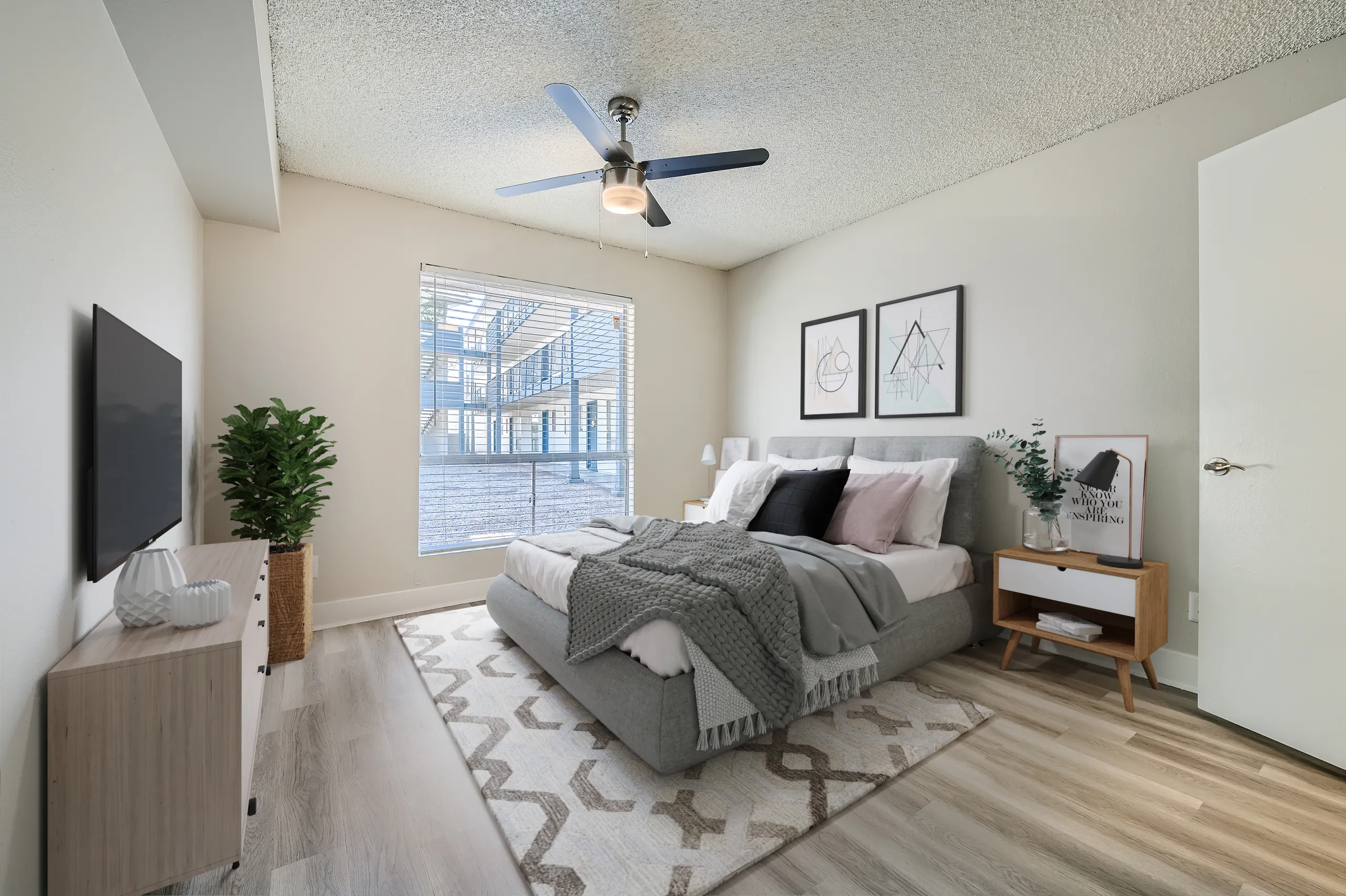 Primary bedroom, ceiling fan, large window, wood-style plank flooring