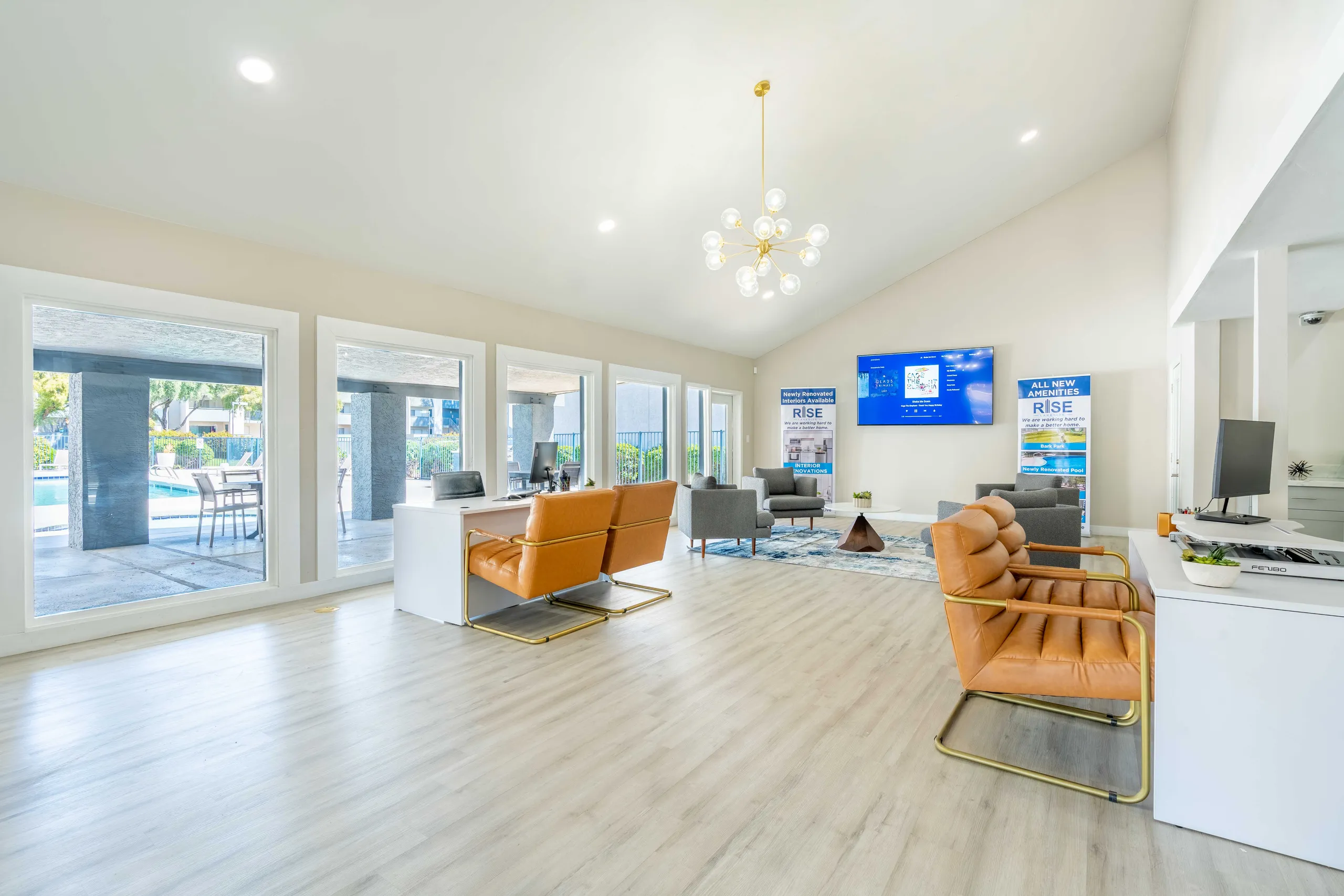 Leasing office lounge, seating area, wall-mounted TV, pool views