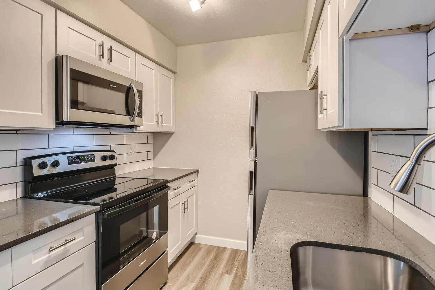 Kitchen, white shaker cabinets, granite countertops, stainless steel appliances