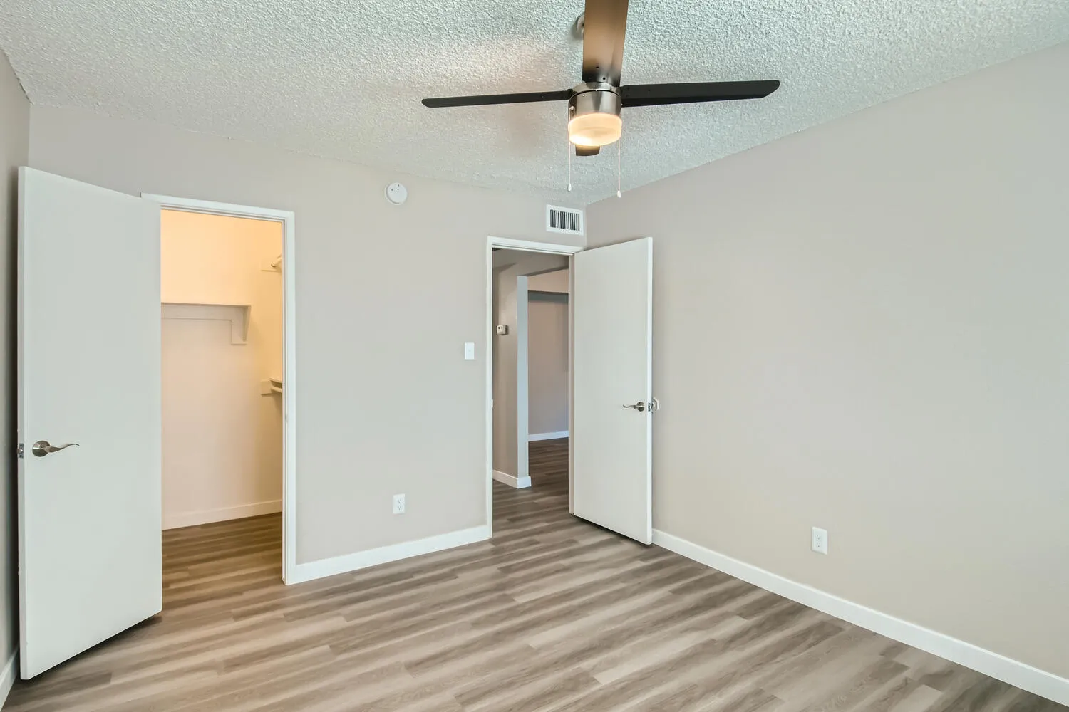 Bedroom, ceiling fan, walk-in closet access, hallway access