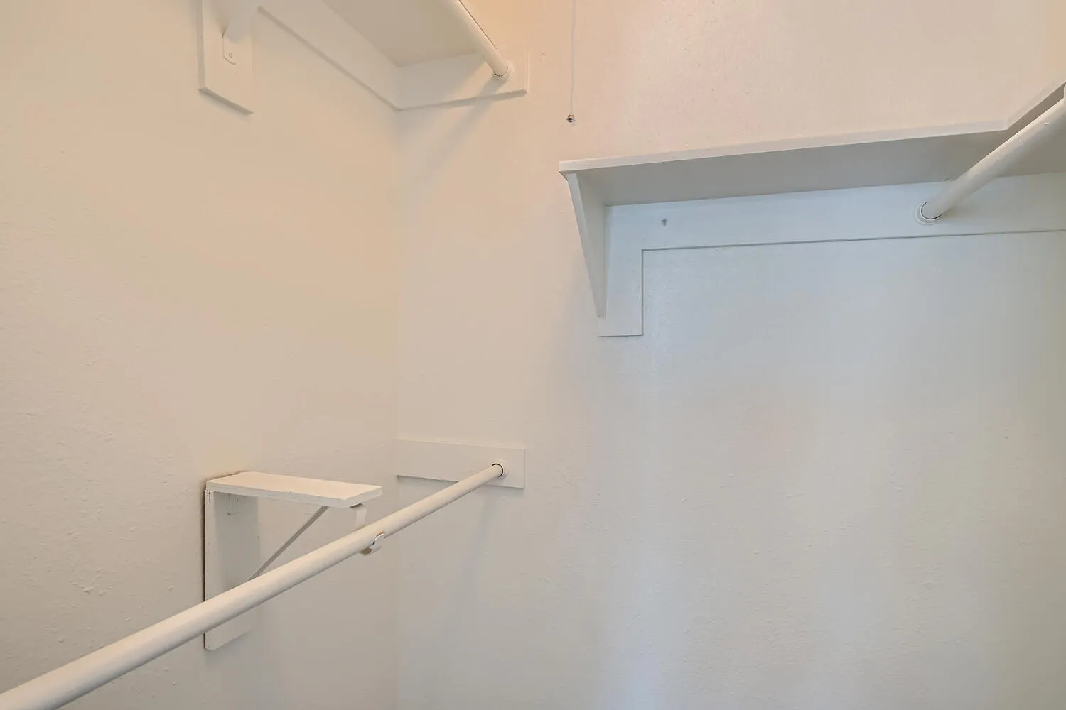 Walk-in closet, built-in shelving, hanging rod storage