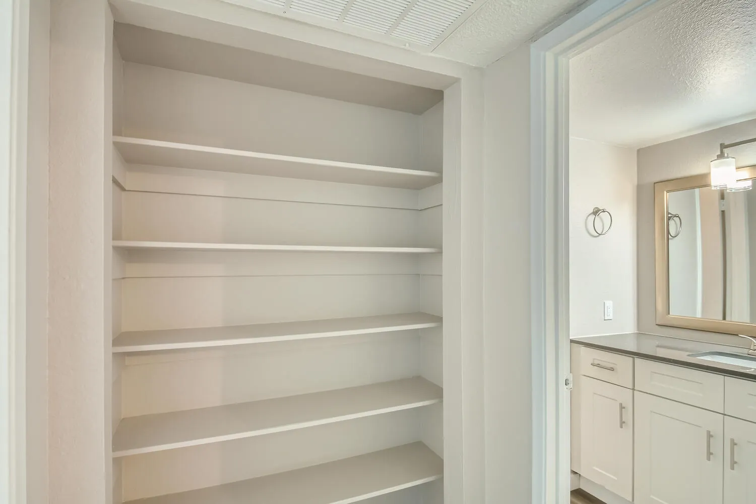 Hallway linen closet, built-in shelving, bathroom access