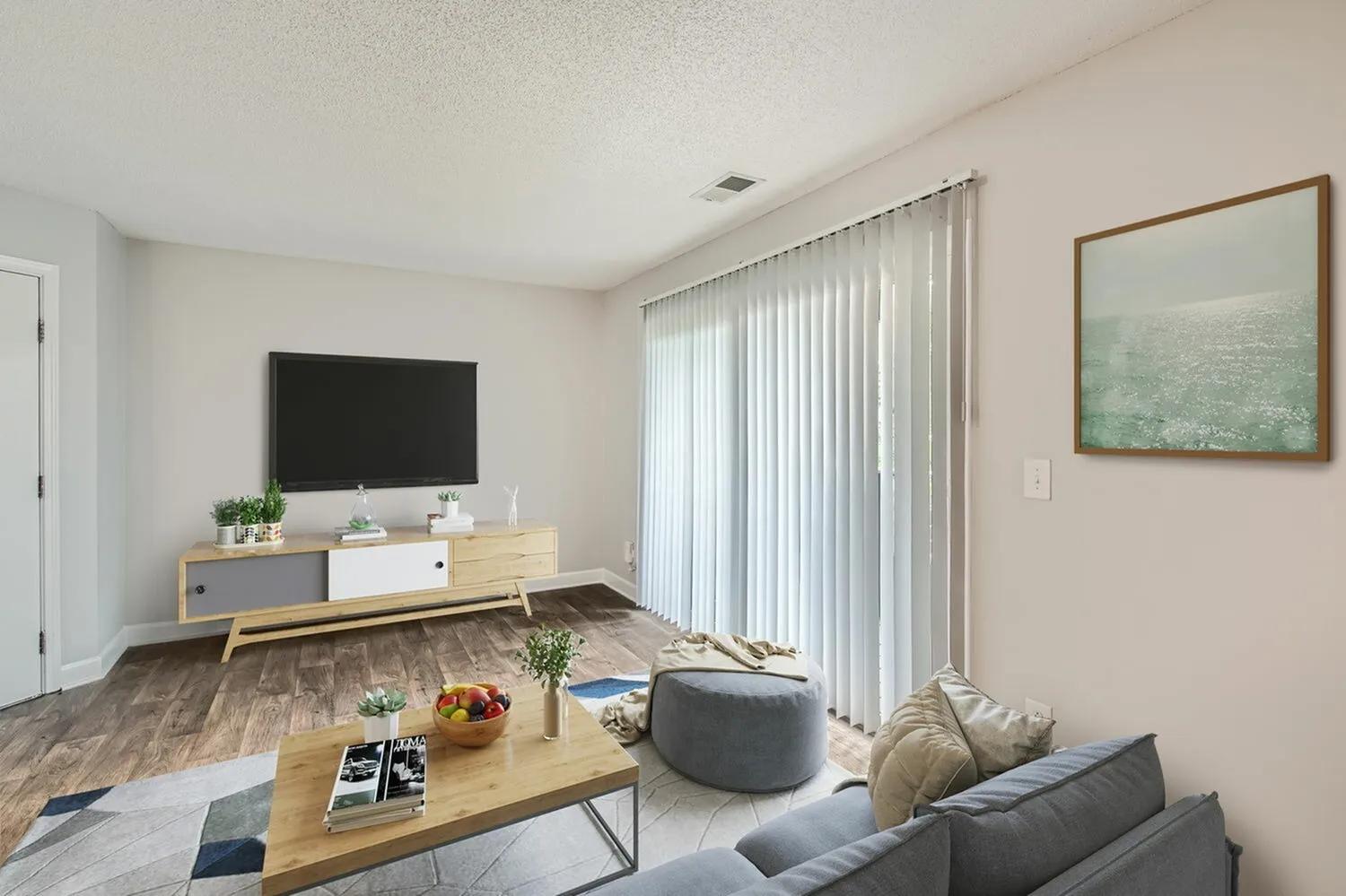 Living room with wood-style plank flooring, sliding glass door