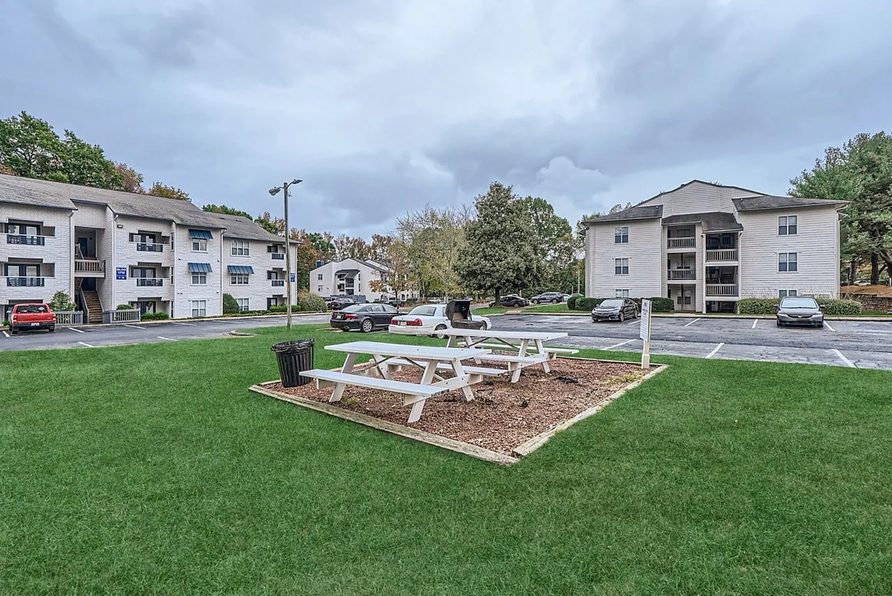 Picnic tables on the community lawn near parking