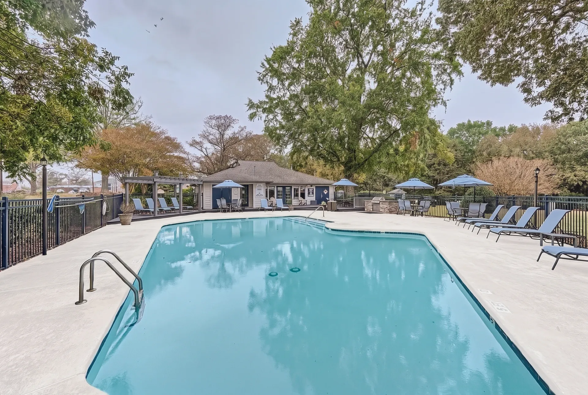 Community pool with cabana and shaded seating area