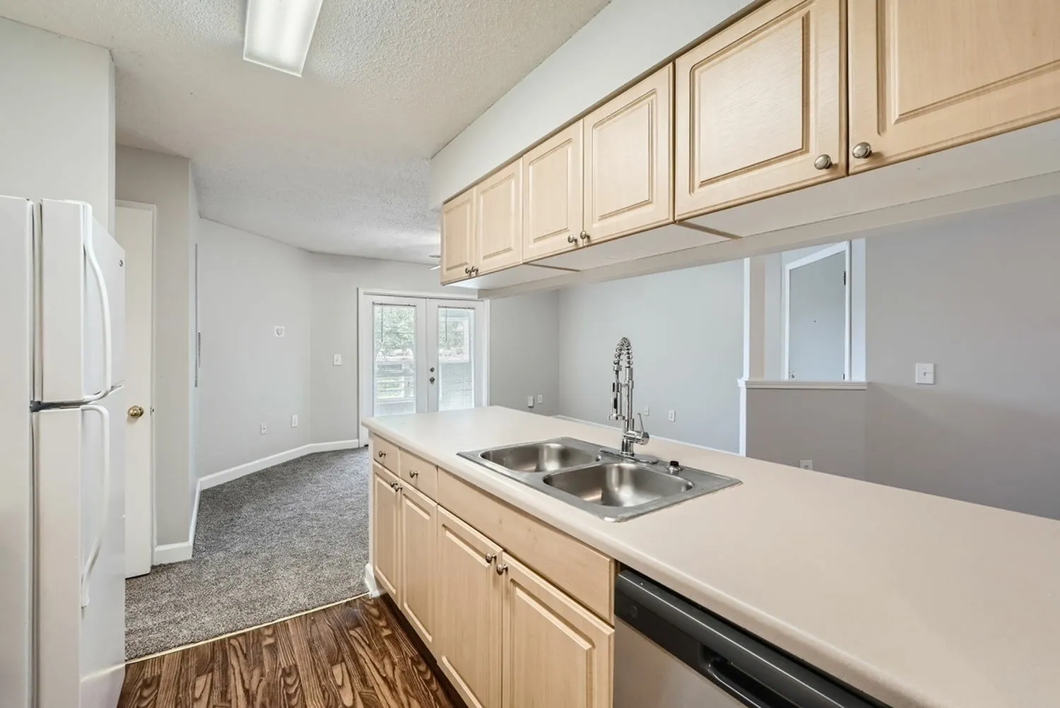 Kitchen with cabinetry, laminate countertops, double basin sink, window