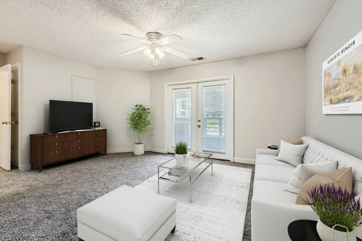 Living room with carpet flooring, sliding glass door to patio