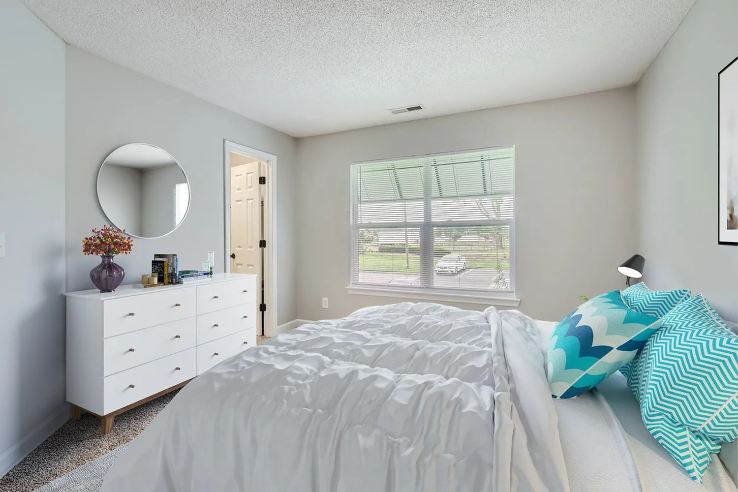 Bedroom with wood-style plank flooring, window with natural light, closet door