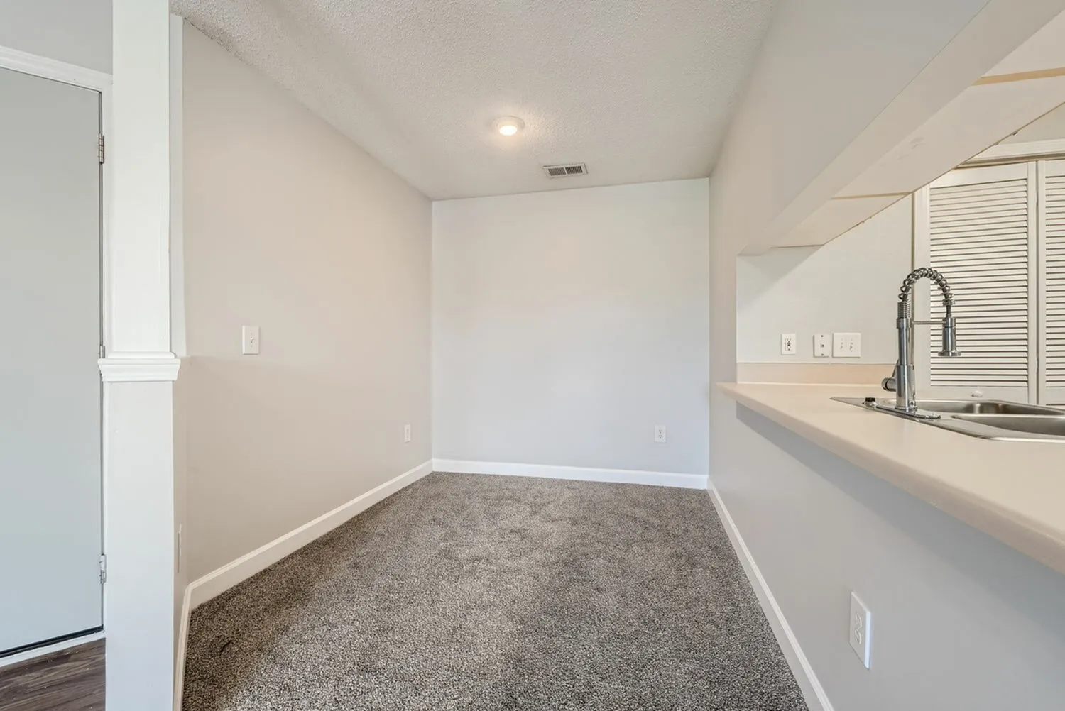 Additional room with wood-style plank flooring, built-in desk nook