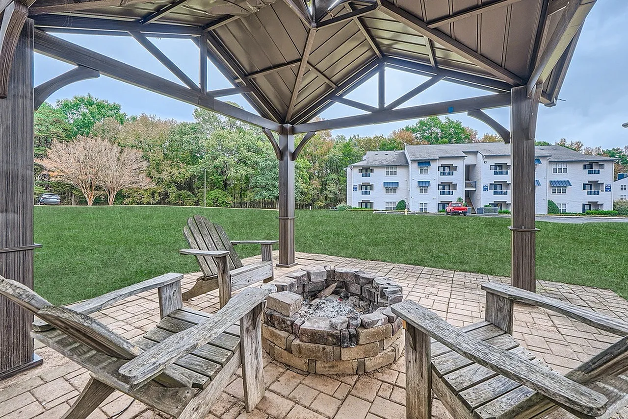 Outdoor fire pit lounge area under a gazebo