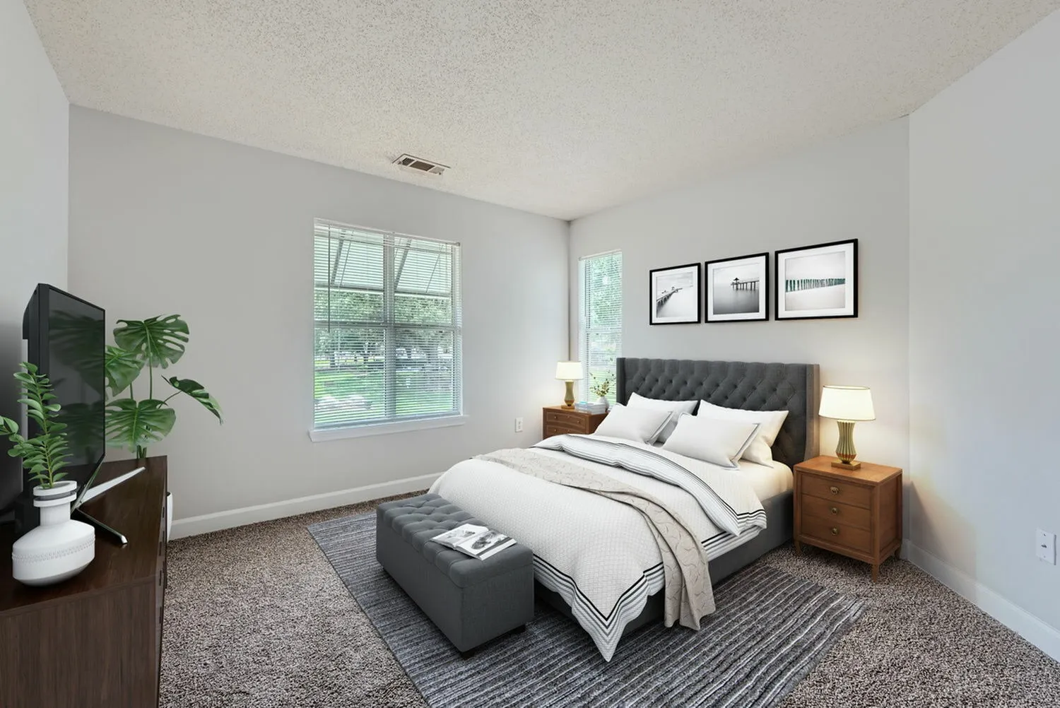 Bedroom with wood-style plank flooring, window with natural light
