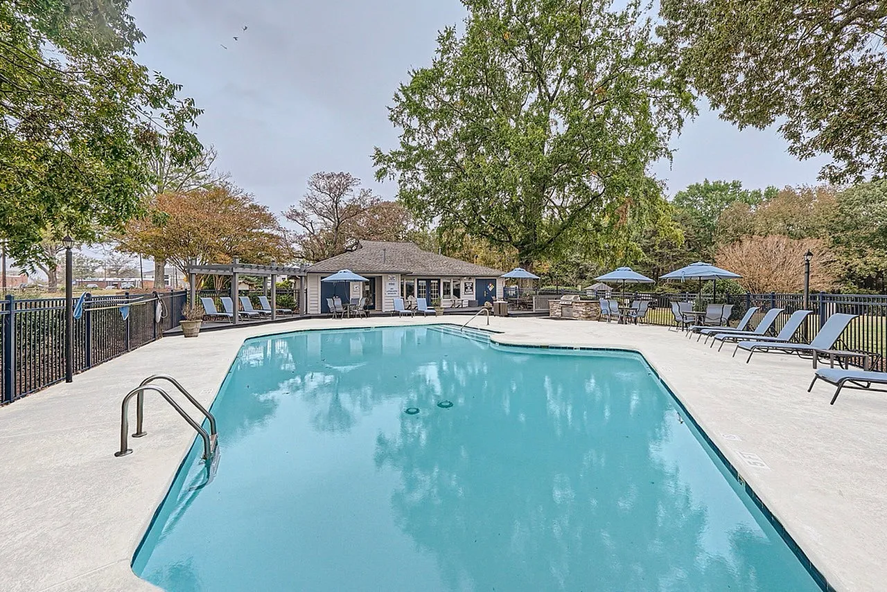 Community pool with cabana and shaded seating area
