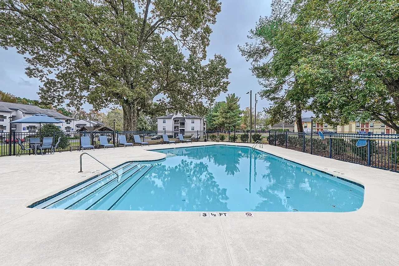 Community pool with entry steps, fenced pool deck