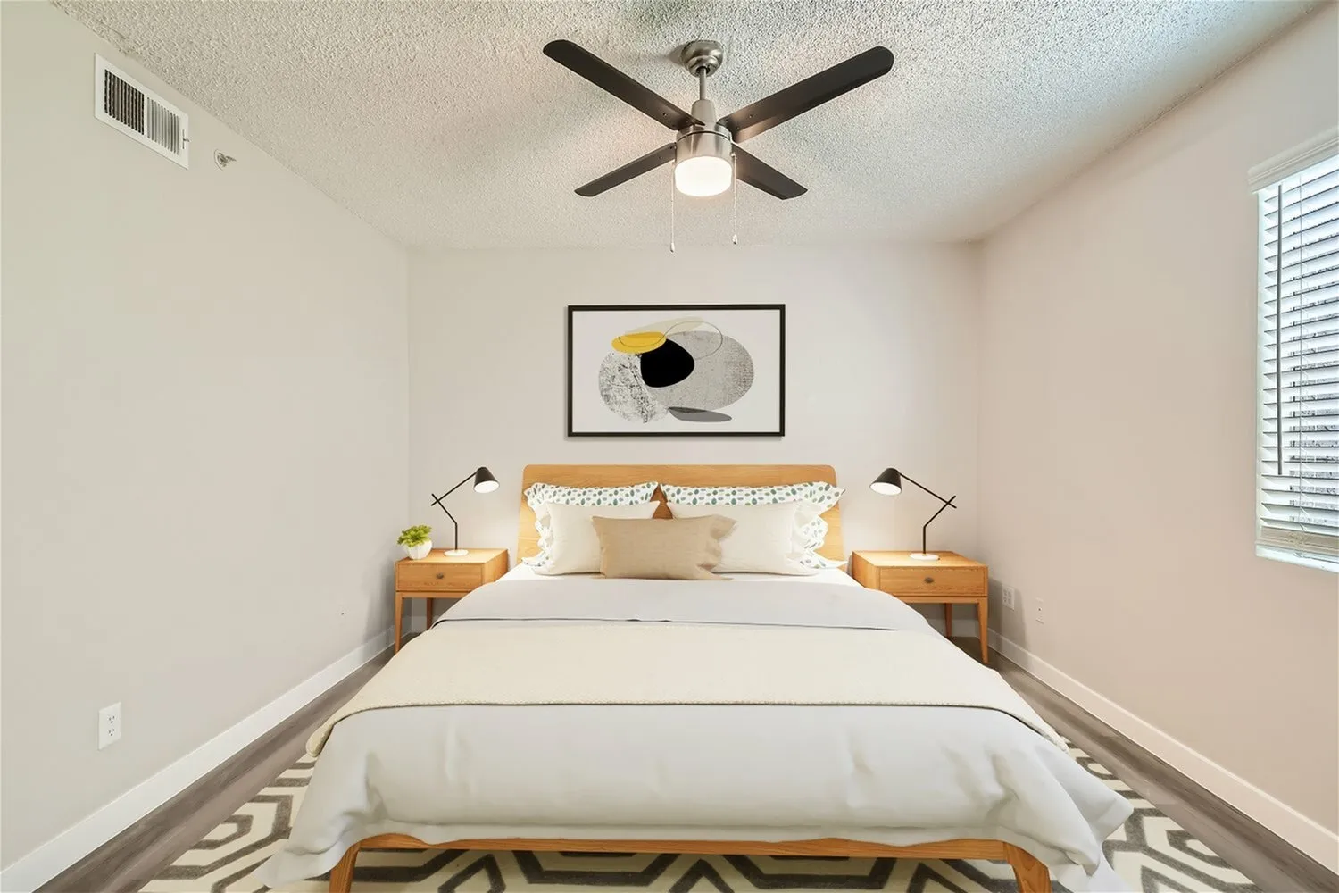 Primary bedroom, wood nightstands, ceiling fan, geometric area rug