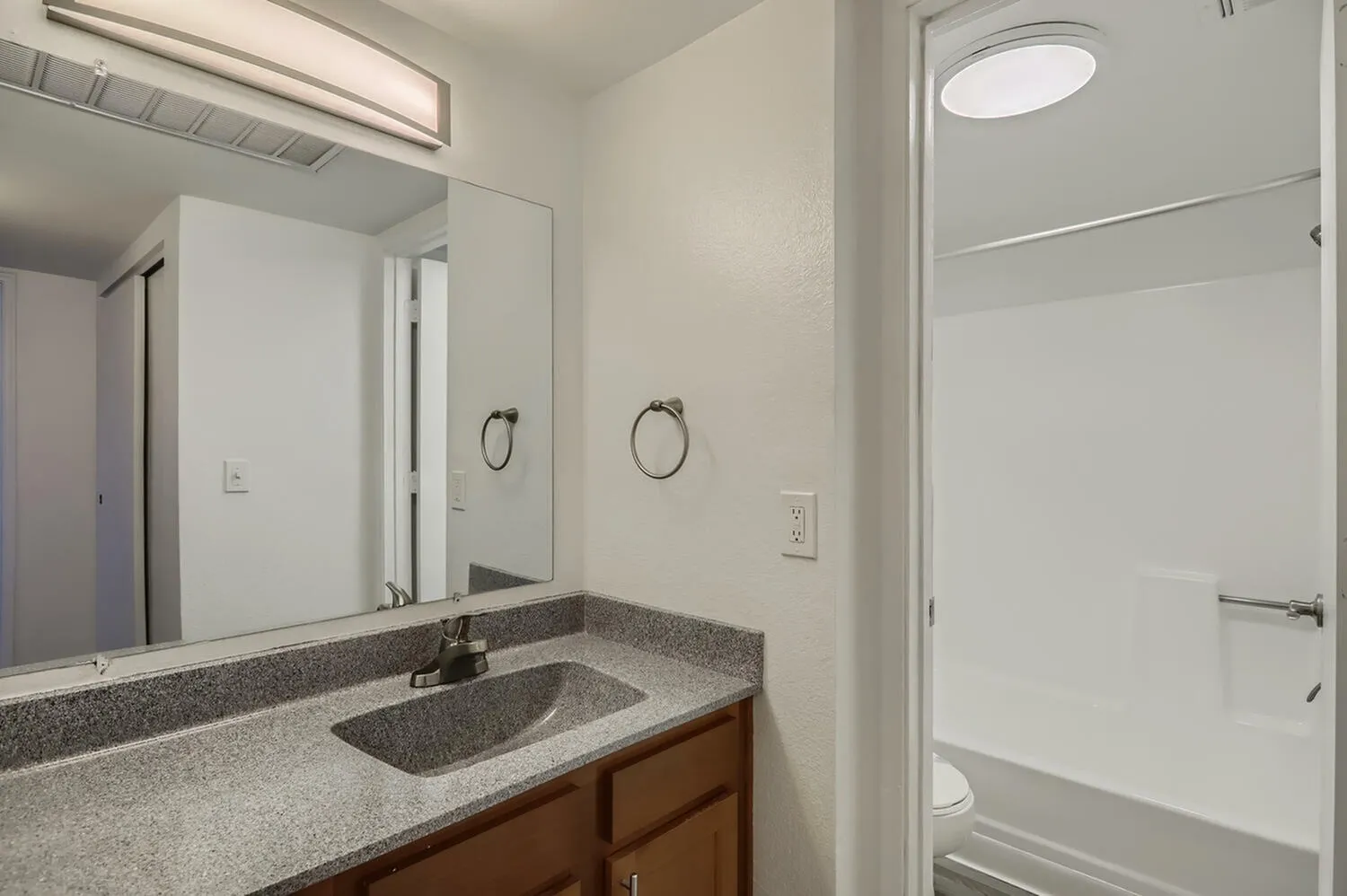 Bathroom, granite countertop, undermount sink, wood vanity cabinet, glass shower enclosure